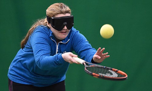 Visually impaired woman playing tennis