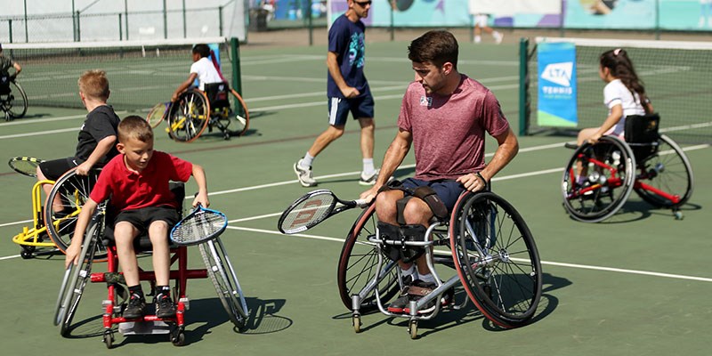 Wheelchair tennis coaching session for juniors