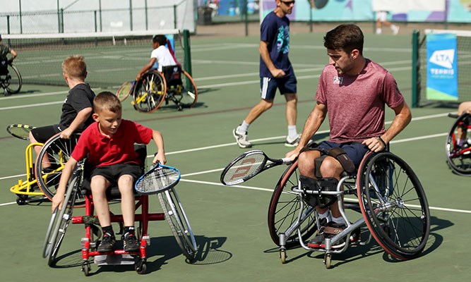 Wheelchair tennis coaching session for juniors