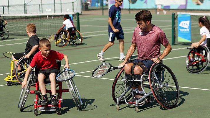 Wheelchair tennis coaching session for juniors