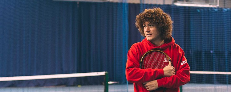 Assistant Manager Rob Start on a tennis court
