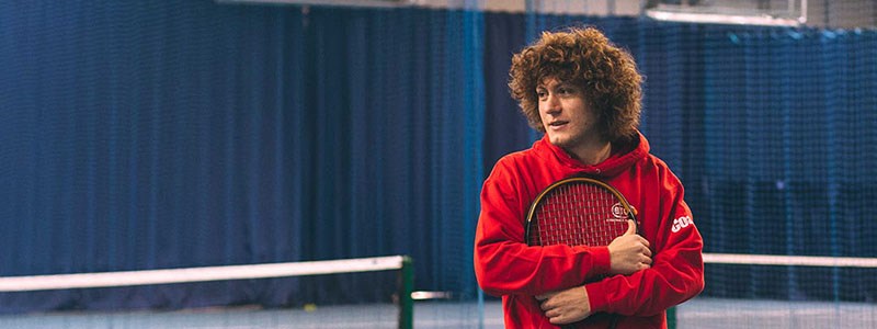 Assistant Manager Rob Start on a tennis court