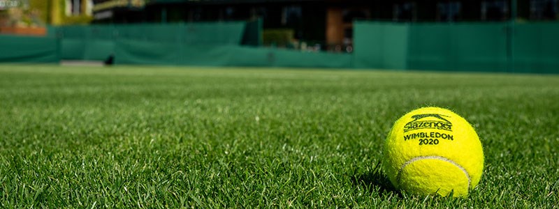 Wimbledon 2020 tennis ball lying on the grass court