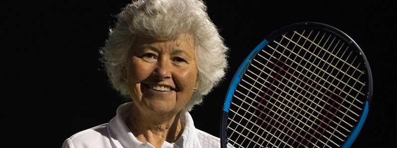 Sarah Strawbridge smiles with her tennis racket in hand