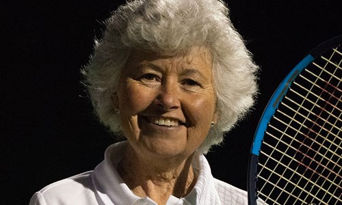Sarah Strawbridge smiles with her tennis racket in hand
