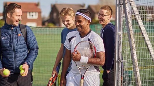 Oli Jones laughing with friends as he enters the court