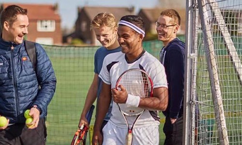 Oli Jones laughing with friends as he enters the court