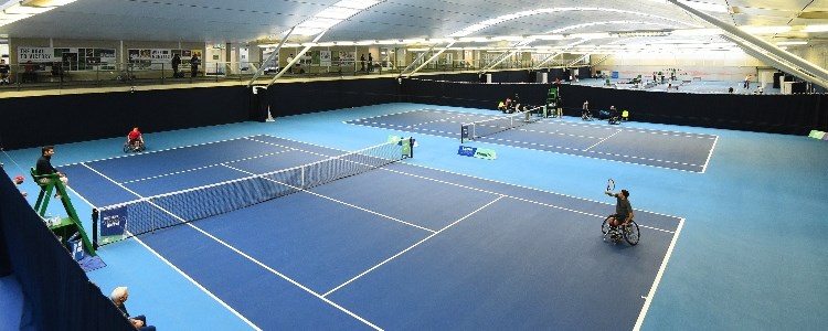A wheelchair match taking place inside at the National Tennis Centre