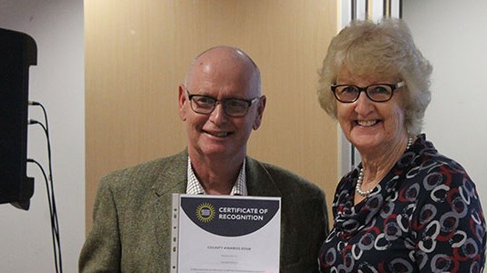 Richard Edgley holding a certificate