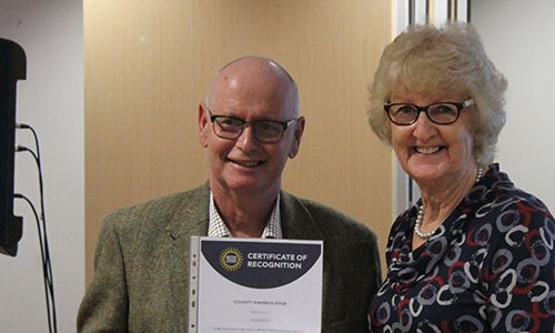 Richard Edgley holding a certificate