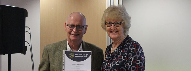 Richard Edgley holding a certificate