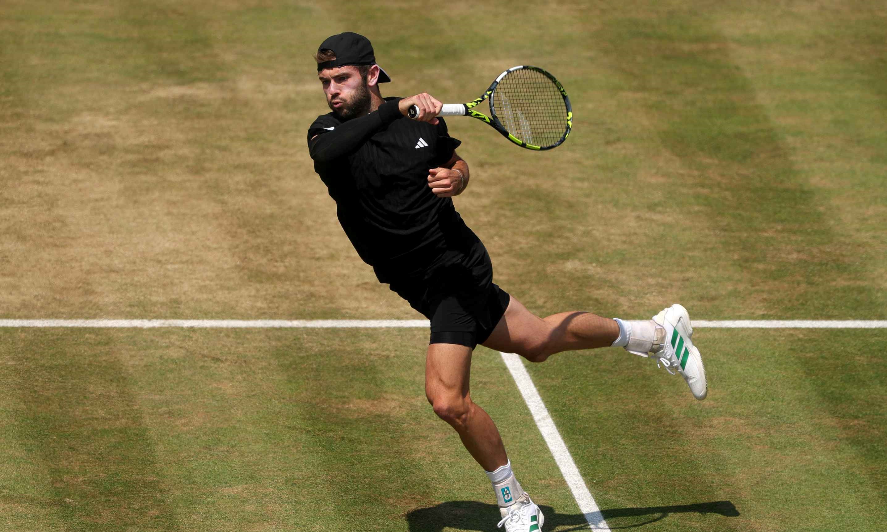 British tennis player Jacob Fearnley hitting a forehand on a grass court at the HSBC Championships