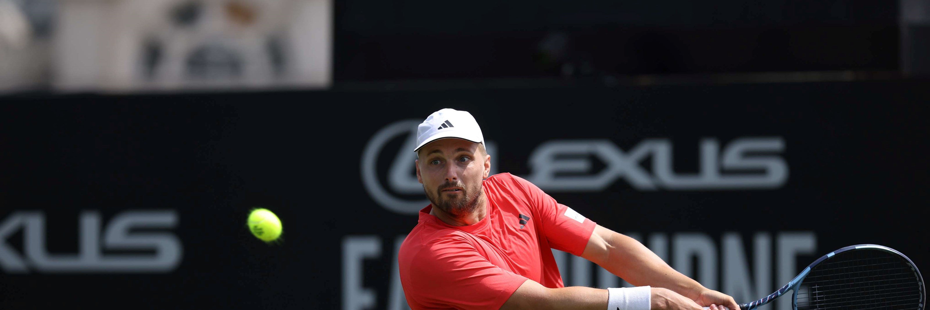 Lloyd Glasspool preparing to hit a backhand on court at the Lexus Eastbourne Open