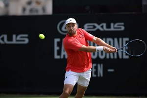Lloyd Glasspool preparing to hit a backhand on court at the Lexus Eastbourne Open