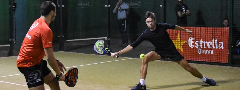 two players on court playing a padel match