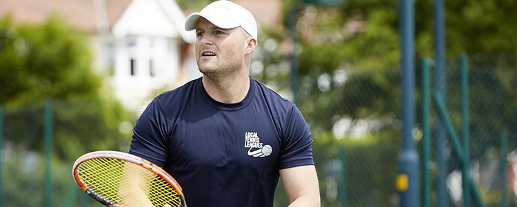Man who works for Local Tennis Leagues holding a tennis racket
