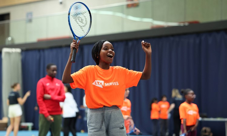 Young child celebrating on court at an LTA SERVES event