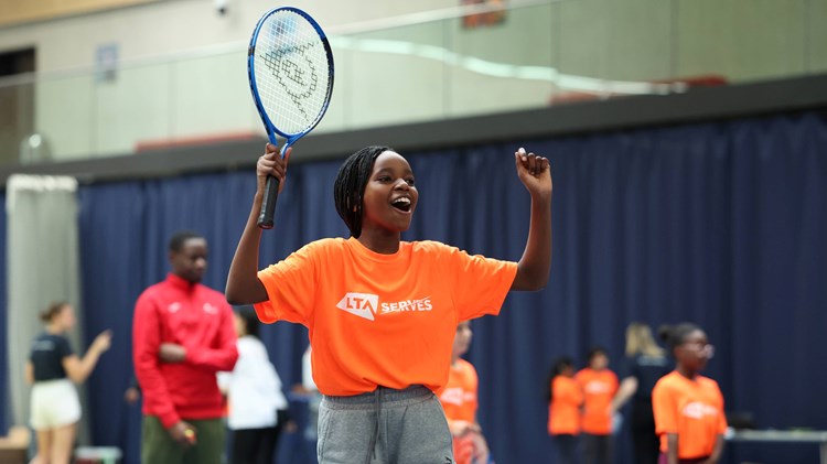 Young child celebrating on court at an LTA SERVES event