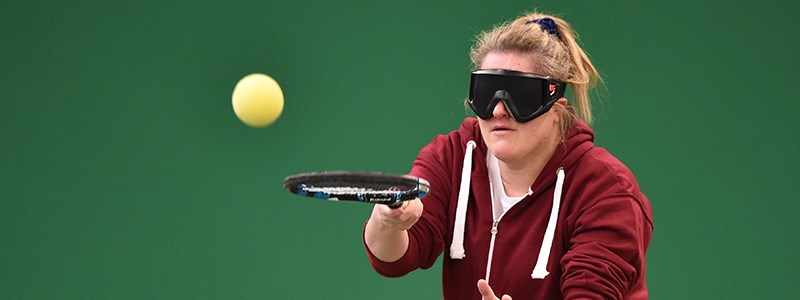 Woman with visual impairment playing tennis