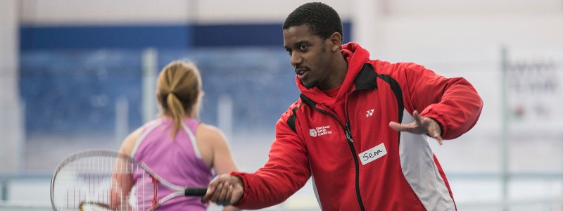 Sena Tengey demonstrating a forehand during a coaching session