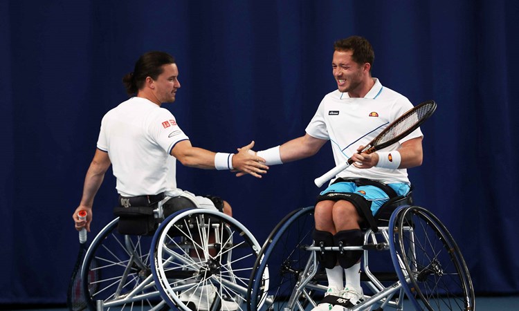 Wheelchair tennis players Alfie Hewett and Gordon Reid high fiving on court at the Lexus British Open 