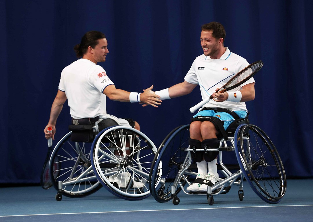 Wheelchair tennis players Alfie Hewett and Gordon Reid high fiving on court at the Lexus British Open 