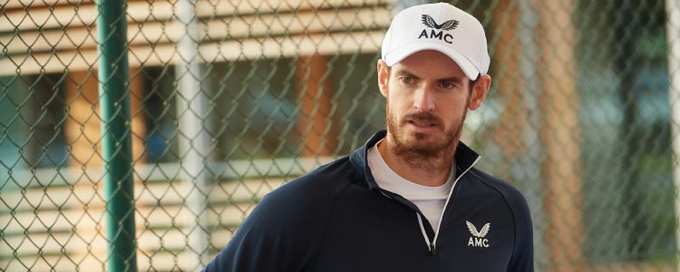 close up image of andy murray on court wearing amc branded jumper and hat