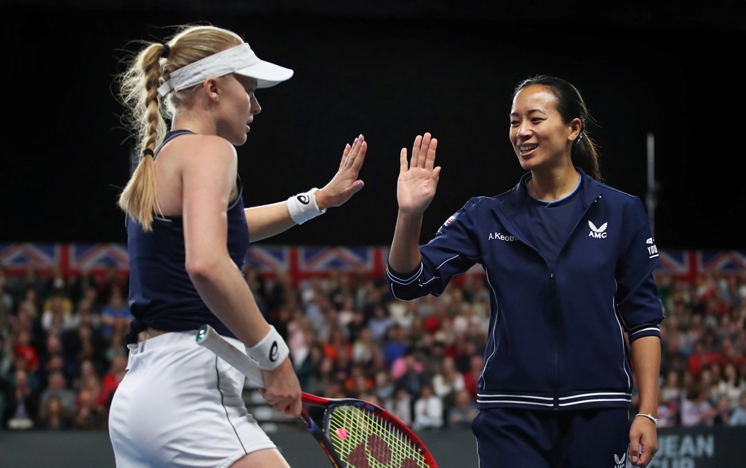 Harriet Dart dressed in her Great Britain Billie Jean King Cup kit high-fiving Anne Keothavong on court during a previous tie