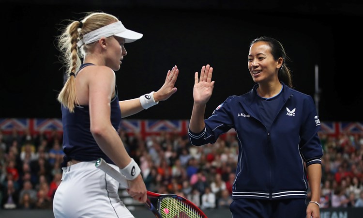 Harriet Dart dressed in her Great Britain Billie Jean King Cup kit high-fiving Anne Keothavong on court during a previous tie