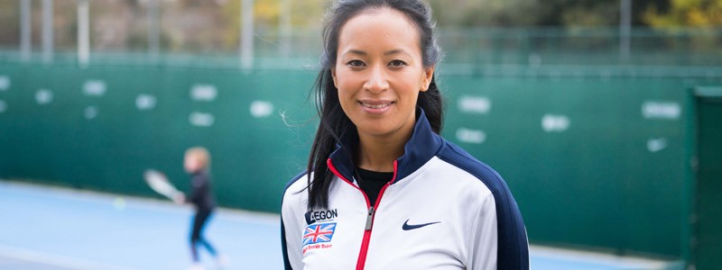 Anne Keothavong smiling on a tennis court