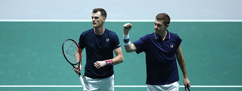 Jamie Murray and Neal Skupski celebrate winning a point on court