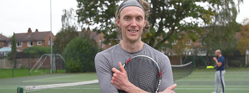 Andy Wright holding a racket close up