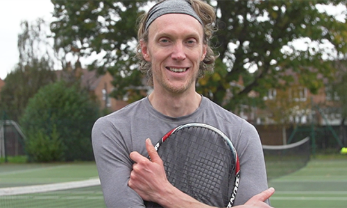 Andy Wright holding a racket close up