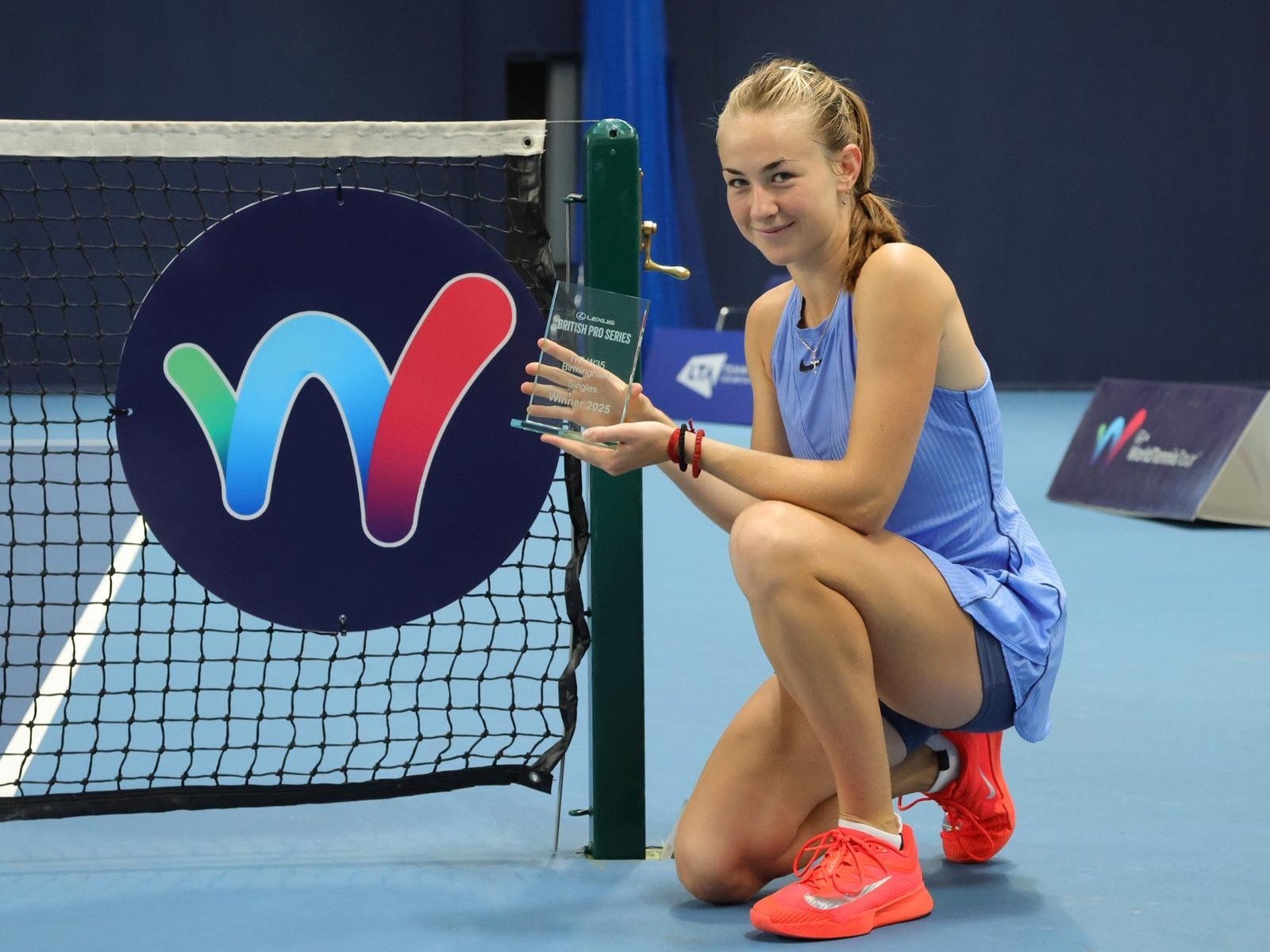 Mika Stojsavljevic holding the singles title on court at the Lexus British Pro Series Birmingham
