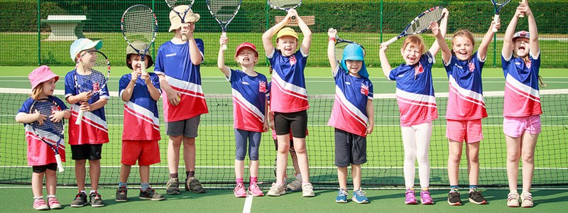 Group of boys and girls cheering for tennis