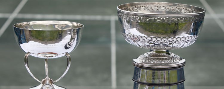 Two silver trophies photographed in front of a tennis court on  for the scottish cup finals at newlands tennis club