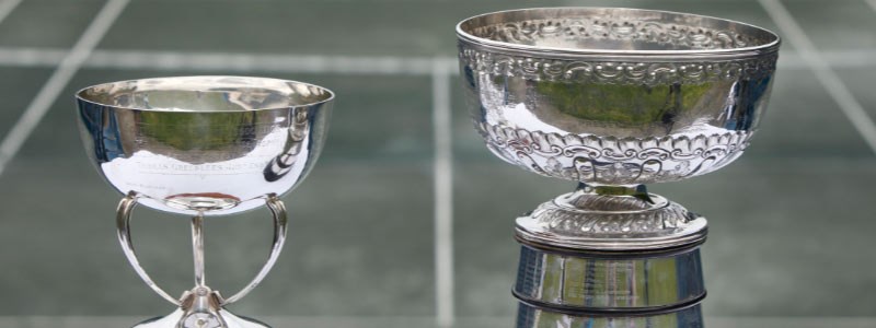 Two silver trophies photographed in front of a tennis court on  for the scottish cup finals at newlands tennis club