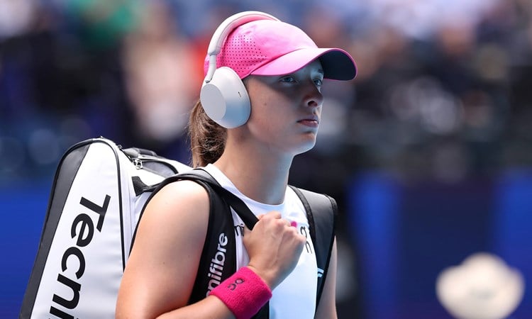 Why do tennis players listen to music before heading on court?