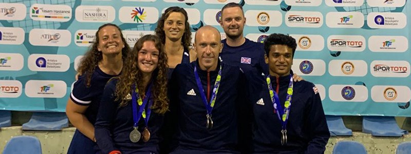 Great British players smiling at the 2019 world deaf tennis championships with medals round neck