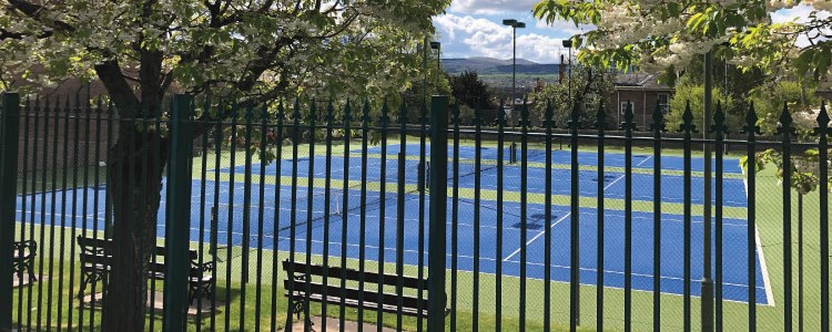 image of three tennis courts taken outside the fence at corstorphine tennis club