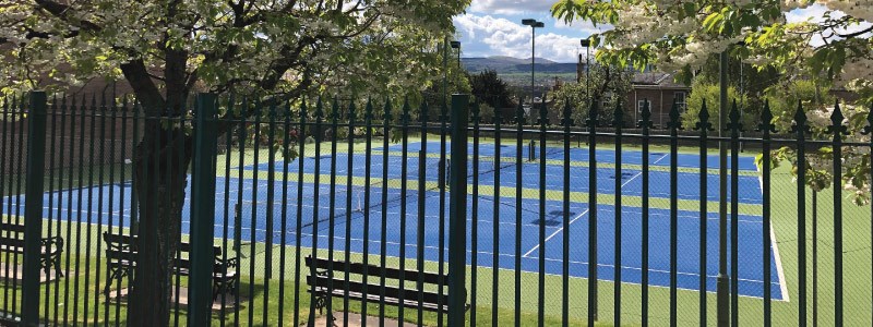 image of three tennis courts taken outside the fence at corstorphine tennis club