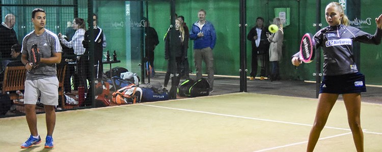 A male and a female playing padel