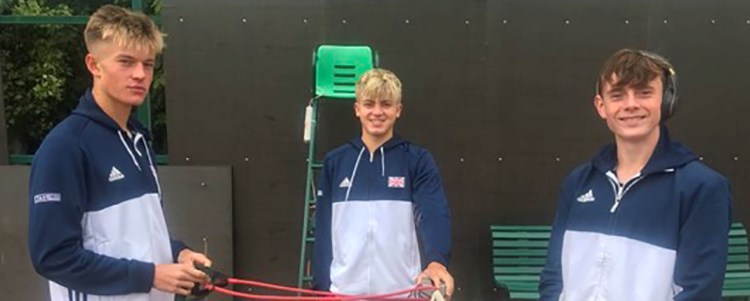 Felix Gill, Jack Pinnington-Jones and Joel Pierleoni smiling on a tennis court