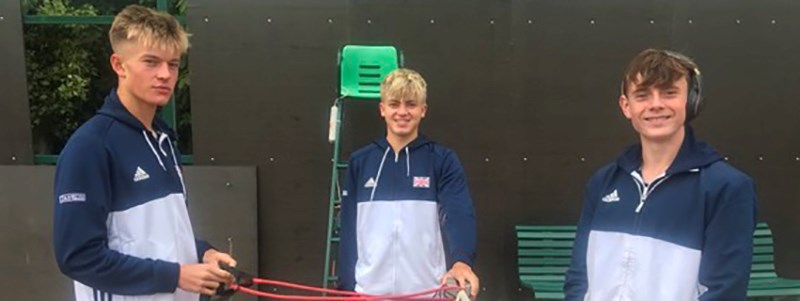 Felix Gill, Jack Pinnington-Jones and Joel Pierleoni smiling on a tennis court