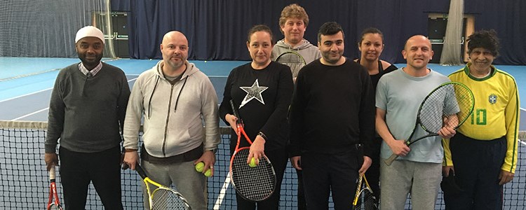 Players pose for a group picture at the net at a Lee valley coaching session