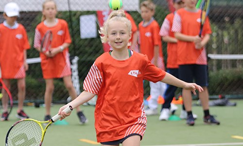 A girl runs to hit a ball as part of the LTA Youth Start programme