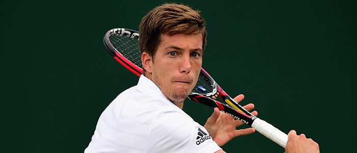 Aljaz Bedene playing a backhand at Wimbledon