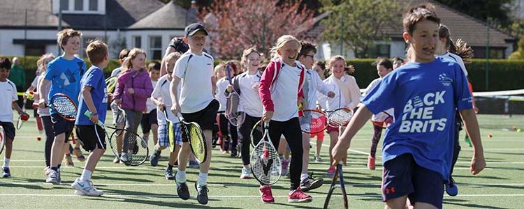 Children running with tennis rackets at Clarkston Tennis Club