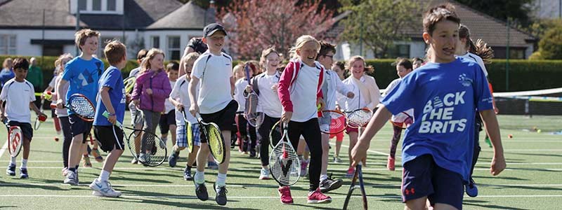 Children running with tennis rackets at Clarkston Tennis Club