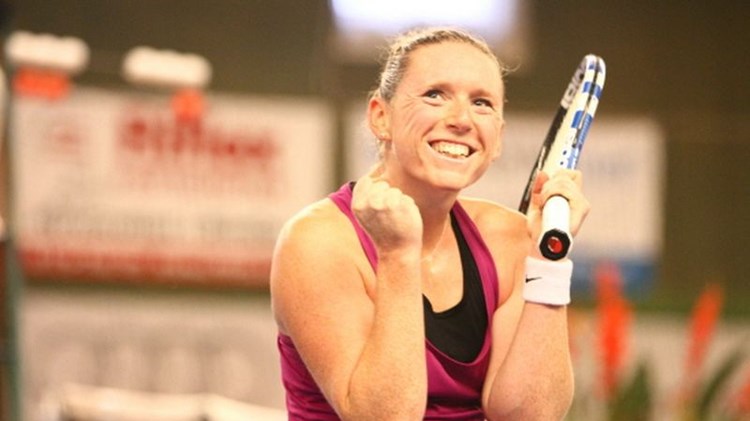 Naomi Cavaday smiling with tennis racket in hand